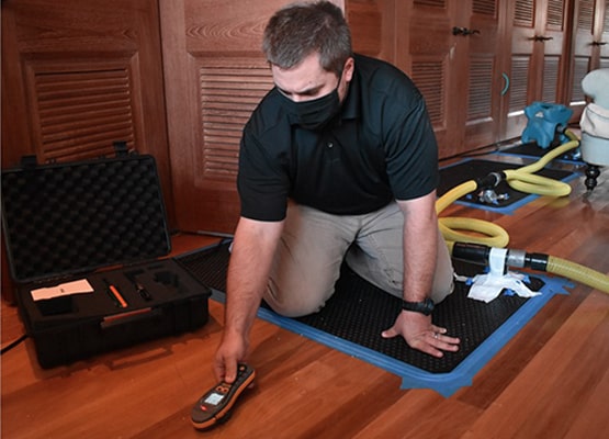 skilled technician detect leak under wood floor
