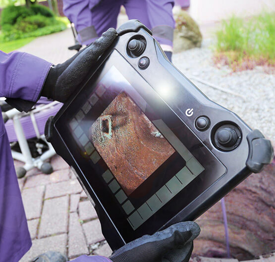 Plumber using sewer camera for drain inspection